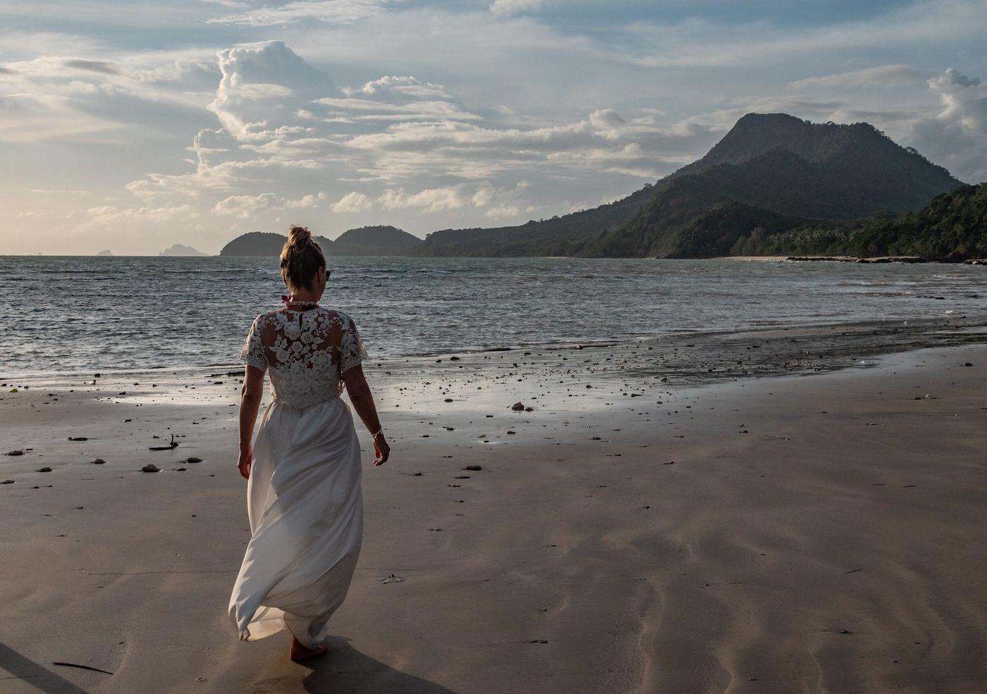 Bride walking on beach