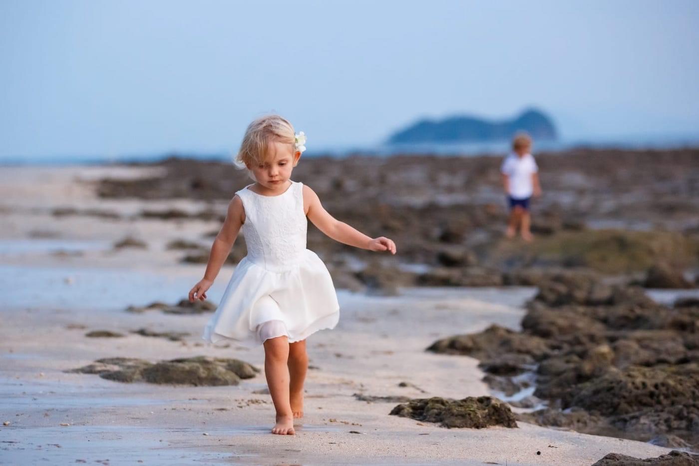 Young bridesmaid walking along beach