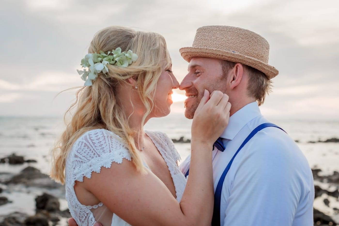 Bride and groom smiling on beach
